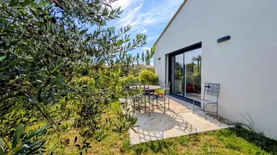 a patio with a table and chairs next to a building at Entre village et campagne in Velleron