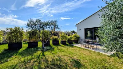 a kitchen and living room with a table and chairs at Entre village et campagne in Velleron