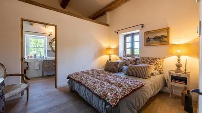 a bedroom with a bed and a large mirror at A typical provençal house in Mollégès