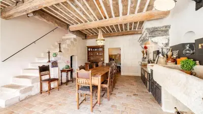 a kitchen with a table and chairs in a room at A typical provençal house in Mollégès