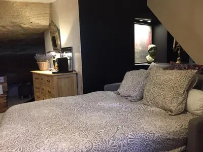 a bedroom with a bed and a dresser with a window at L'oustau étoilé in Gordes