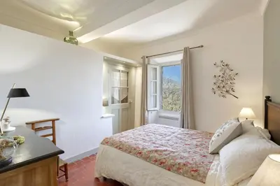 a bedroom with a bed and a window at L'oustau étoilé in Gordes