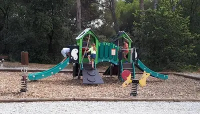 a childrens playground with a small green playground at Maison Les Demeures du Ventoux in Aubignan