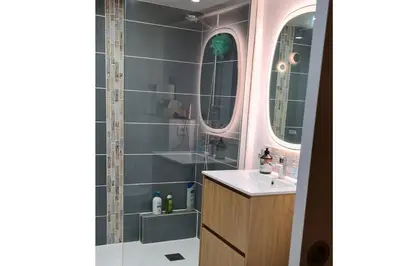 a bathroom with a sink and a shower with two mirrors at Havre de paix au coeur historique in Aix-en-Provence
