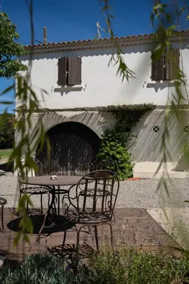 a table and a bench in front of a building at Estate in Provence in Aix-en-Provence