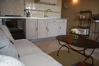 a kitchen with a couch and a table and a sink at mas des oliviers in Gordes