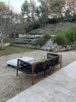 a bed sitting on the ground in a garden at Appartement dans Aix-en-Provence - Sainte Victoire in Saint-Marc-Jaumegarde