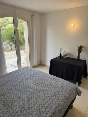 a bedroom with a bed and a table with a black table cloth at Appartement dans Aix-en-Provence - Sainte Victoire in Saint-Marc-Jaumegarde