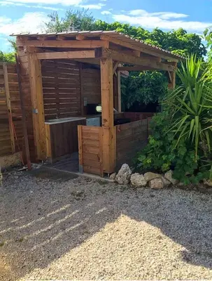 a wooden pergola sitting on top of a yard at Studio Velaux in Velaux