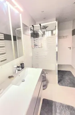 a white bathroom with a sink and a shower at Villa grand confort, piscine privée, petanque, pool house in Alleins