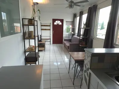a kitchen and living room with a couch and a table at Provence Studio 33 m2 in Cavaillon