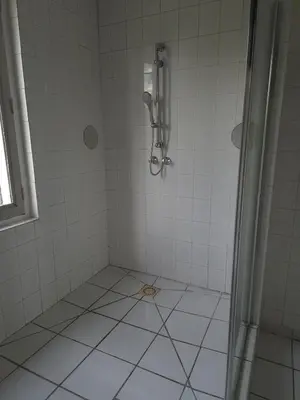 a bathroom with a shower with white tiles at Provence Studio 33 m2 in Cavaillon