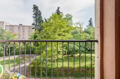 a balcony with a view of a park at T4 Aix PARKING CLIM refait a neuf in Aix-en-Provence