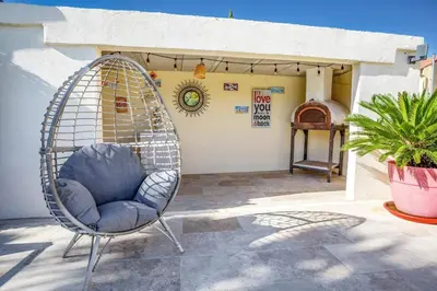a swing chair on a patio with a house at Villa Valleron by Villa Plus in Saint-Saturnin-les-Avignon