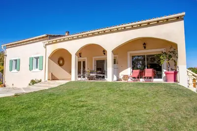 a house with a lawn in front of it at Villa Valleron by Villa Plus in Saint-Saturnin-les-Avignon