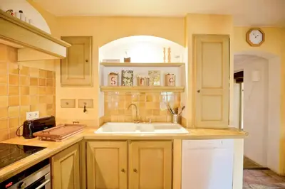 a kitchen with a sink and a counter top at Stone House Within Castle Ramparts In Goult in Goult
