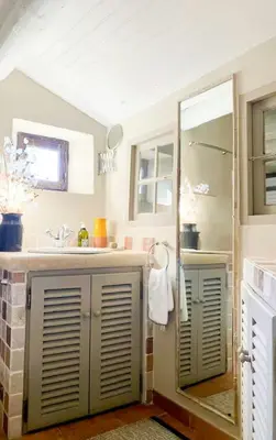 a bathroom with a shower and a sink at Stone House Within Castle Ramparts In Goult in Goult