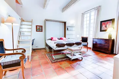 a bedroom with a bed and a ladder in a room at Aude Loft in Aix-en-Provence