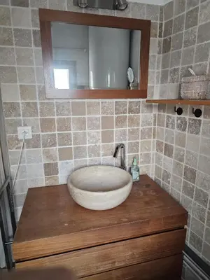 a bathroom with a sink and a mirror on a counter at Duplex entre Palais de justice et Cours Mirabeau, Climatisation in Aix-en-Provence