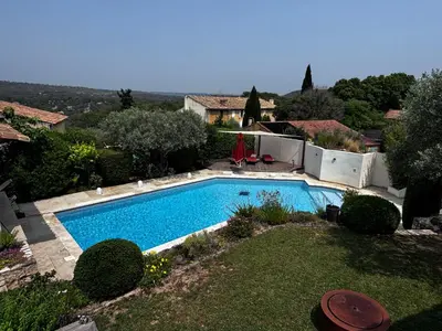 a swimming pool in the yard of a house at Maison V in Ventabren