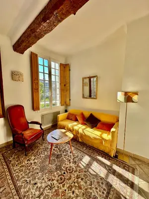 a living room with a couch and a chair at - Élégant cocon au cœur du centre historique - in Aix-en-Provence