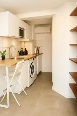 a kitchen with a sink and a washing machine at T2 Duplex climatisé Suite et canapé-lit Aix centre in Aix-en-Provence