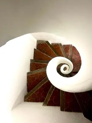 a spiral staircase in a building with a spiral at T2 Duplex climatisé Suite et canapé-lit Aix centre in Aix-en-Provence