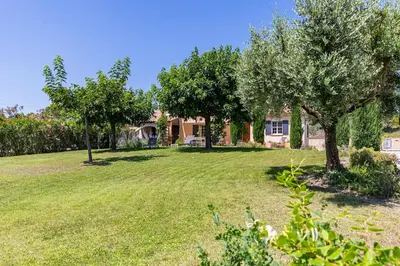 a yard with trees in front of a house at Villa A l'ombre du Géant climatisée piscine pour 8 personnes in Saint-Pierre-de-Vassols