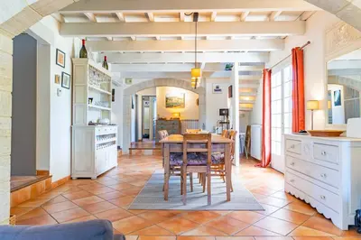 a kitchen with a table and a dining room at Villa A l'ombre du Géant climatisée piscine pour 8 personnes in Saint-Pierre-de-Vassols