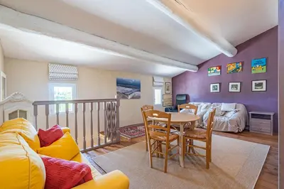 a living room with a couch and a table at Villa A l'ombre du Géant climatisée piscine pour 8 personnes in Saint-Pierre-de-Vassols