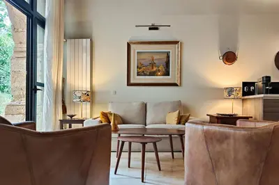 a living room with a couch and some chairs at Beautiful duplex, historic center, private garden in Aix-en-Provence