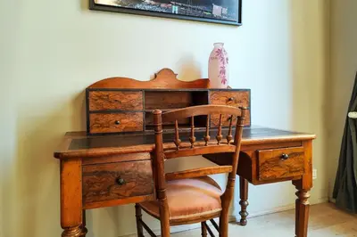 an old wooden desk with a chair next to it at Beautiful duplex, historic center, private garden in Aix-en-Provence