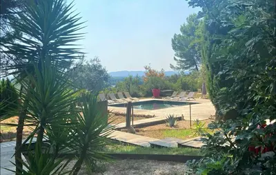 a pool in a yard with chairs and trees at Maison Piscine Proche Alpilles in Noves