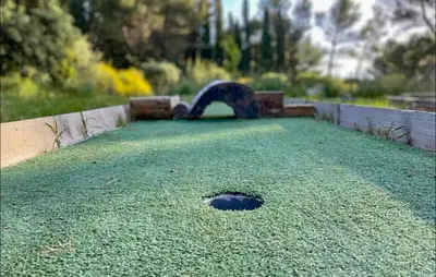 a large green yard with a hole in the middle at Maison Piscine Proche Alpilles in Noves