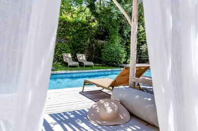 a view of a pool from the porch of a house at Modern Loft With Pool Near Lourmarin in Puget