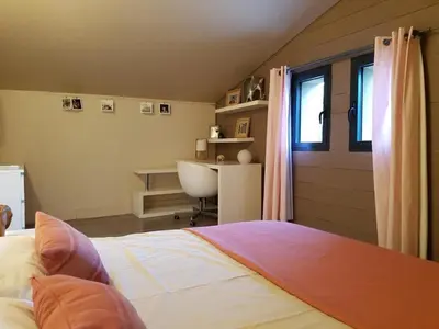 a bedroom with a bed and a desk and a window at Modern Loft With Pool Near Lourmarin in Puget