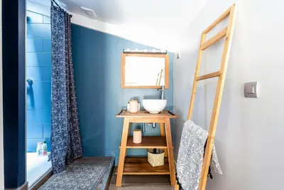 a bathroom with a blue wall and a sink at Modern Loft With Pool Near Lourmarin in Puget