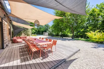 a patio with a table and chairs under a canopy at Modern Loft With Pool Near Lourmarin in Puget