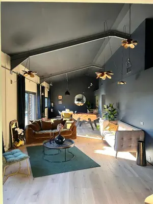 a living room with couches and a table at Modern Loft With Pool Near Lourmarin in Puget