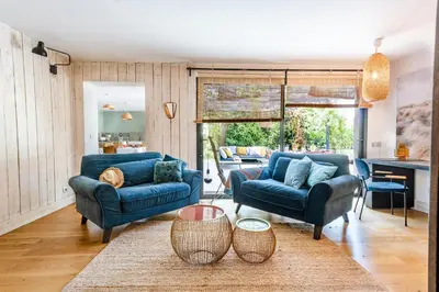 a living room with two blue couches and a table at House With Rooftop Terrace And Pool In Lourmarin in Puget