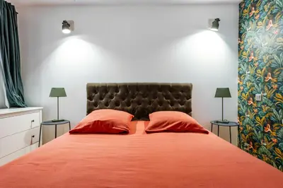 a bedroom with a large bed with two red pillows at House With Rooftop Terrace And Pool In Lourmarin in Puget