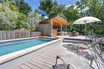an outdoor pool with a table and chairs and an umbrella at House With Rooftop Terrace And Pool In Lourmarin in Puget