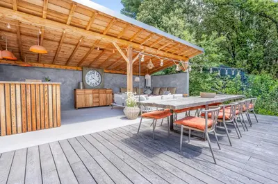 a patio with a table and chairs on a deck at House With Rooftop Terrace And Pool In Lourmarin in Puget