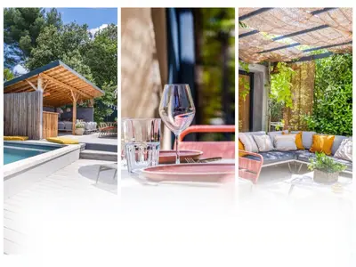 a glass of wine sitting on a table next to a house at House With Rooftop Terrace And Pool In Lourmarin in Puget