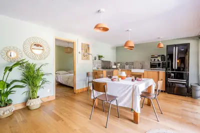 a dining room and kitchen with a table and chairs at House With Rooftop Terrace And Pool In Lourmarin in Puget