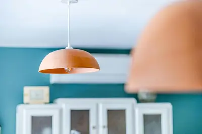 a light hanging from the ceiling of a kitchen at House With Rooftop Terrace And Pool In Lourmarin in Puget