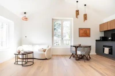 a living room with a couch and a table at Grand Cèdre in Aix-en-Provence