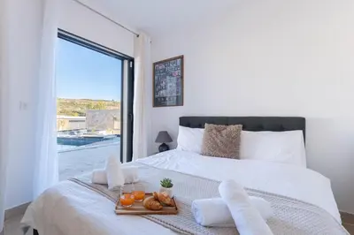 a bedroom with a bed with a tray of food on it at Aria Blue - Spacieuse - Climatisée - Piscine in Lançon-Provence