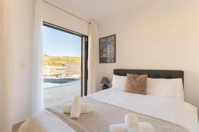 a bedroom with a bed and a large window at Aria Blue - Spacieuse - Climatisée - Piscine in Lançon-Provence