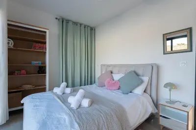 a bedroom with a bed with stuffed animals on it at Aria Blue - Spacieuse - Climatisée - Piscine in Lançon-Provence
